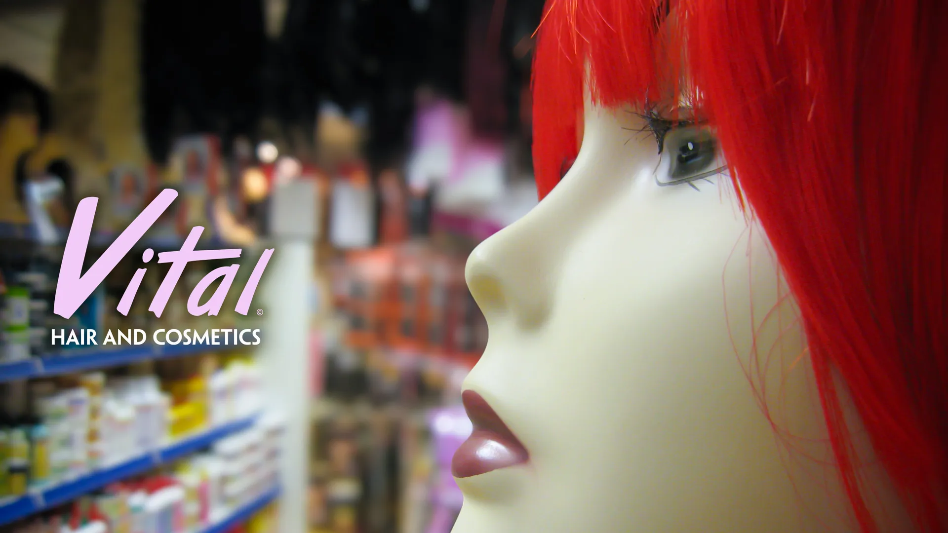 Close up of a wig model next to the Vital logo